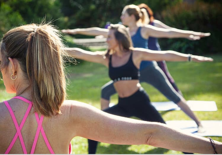 Warrior pose class in golden evening light